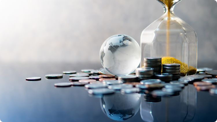 An hourglass with coins and a globe, symbolizing the concept of investing.