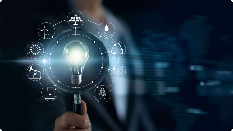 A businessman examining a light bulb with a magnifying glass with icons representing different technologies.