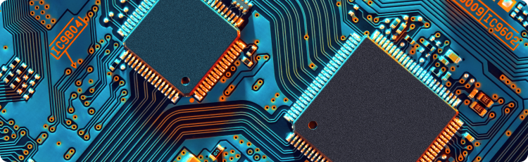 Uma sÃ©rie de cores numa placa de circuitos de um computador, destacando vÃ¡rios elementos electrÃ³nicos como semicondutores e ligaÃ§Ãµes