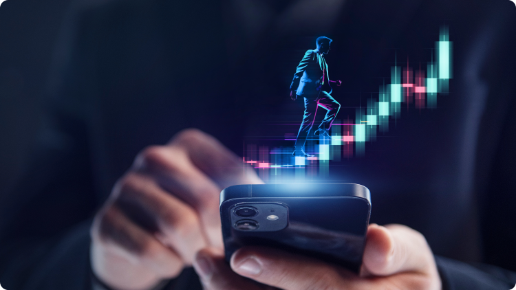 A businessman in a suit holding a smartphone displaying a graph with a man representing rising stock prices
