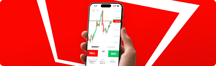 Uma pessoa segurando um smartphone contra um fundo vermelho vibrante