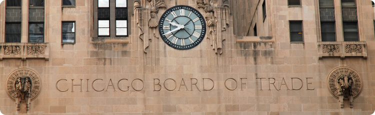 A clock mounted on the exterior wall of the building of the Chicago Board of Trade, displaying the time prominently