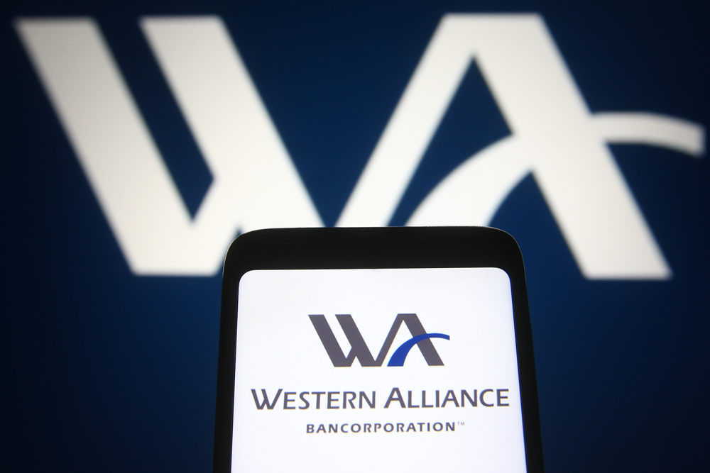 El logo del western alliance en una pantalla de telefono y en el fondo