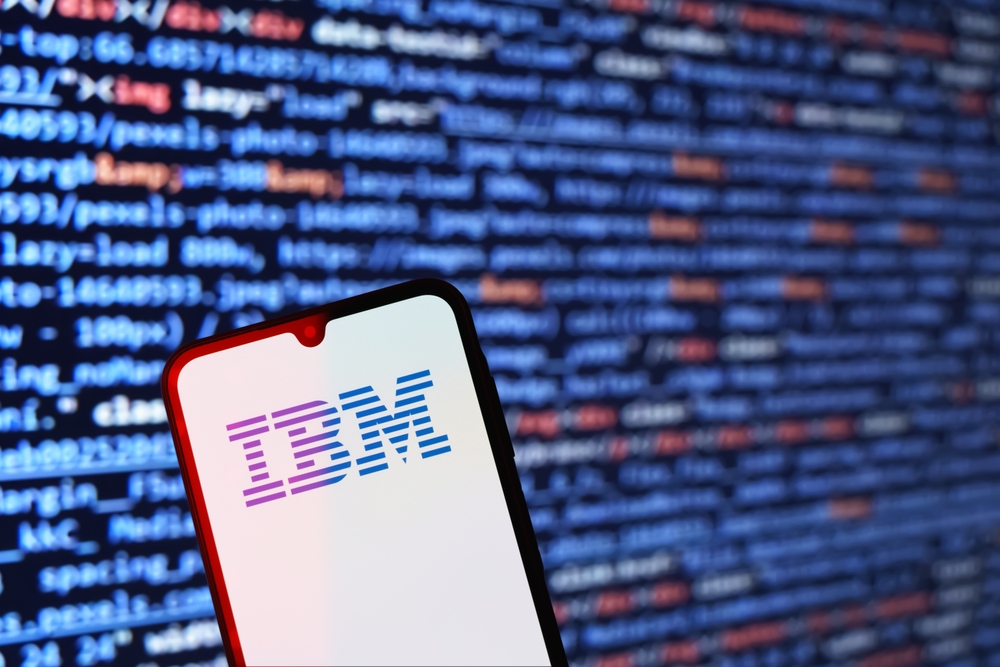 Una pantalla de telefono con el logo de IBM con varios codigos en el fondo