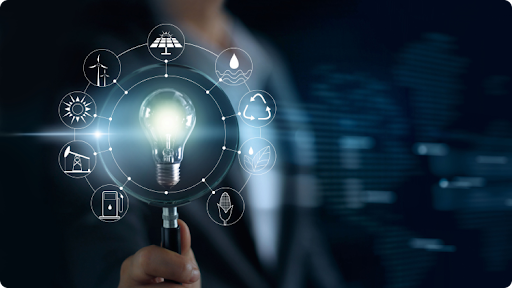  A businessman examining a light bulb with a magnifying glass with icons representing different technologies.