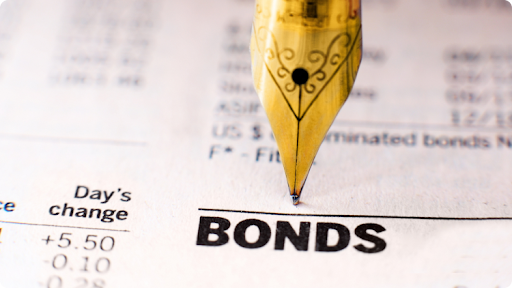 a vintage pen pointing a âbondsâ word printed on a bond document with bonds quotes
