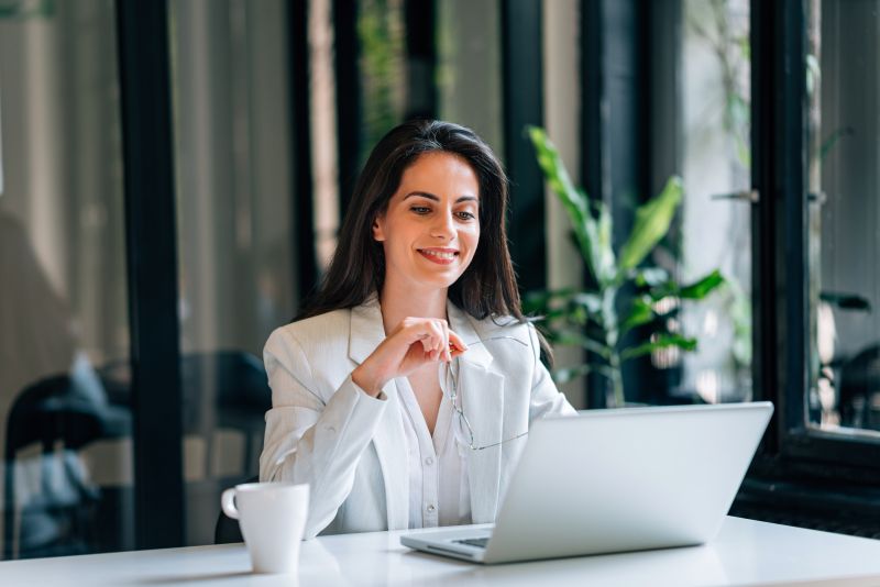 Imagen de una mujer frente a un ordenador en un artÃ­culo sobre cÃ³mo elegir un brÃ³ker para invertir en renta fija como PYME