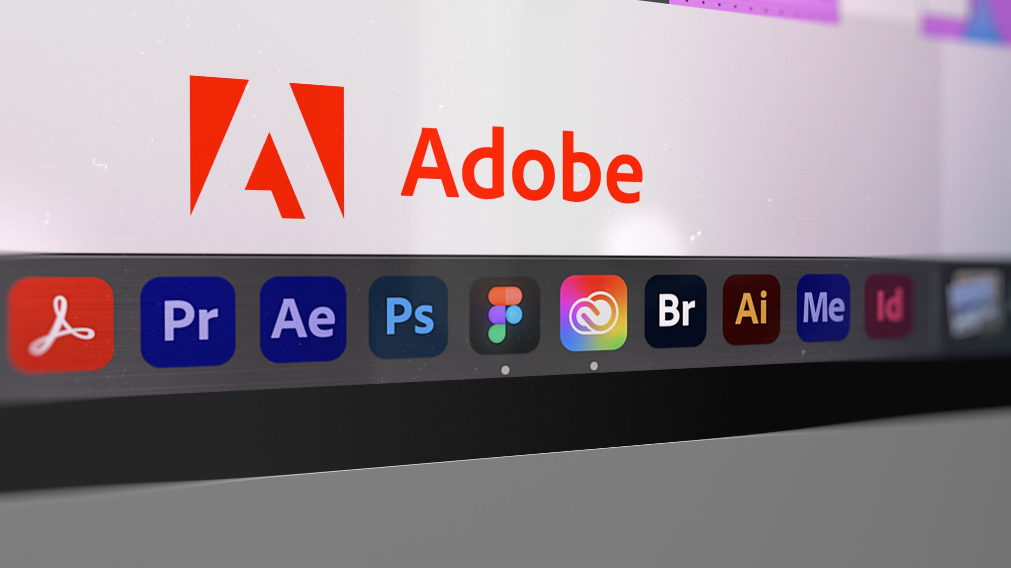 Imagen de un ordenador en el que se ven los logos de Adobe