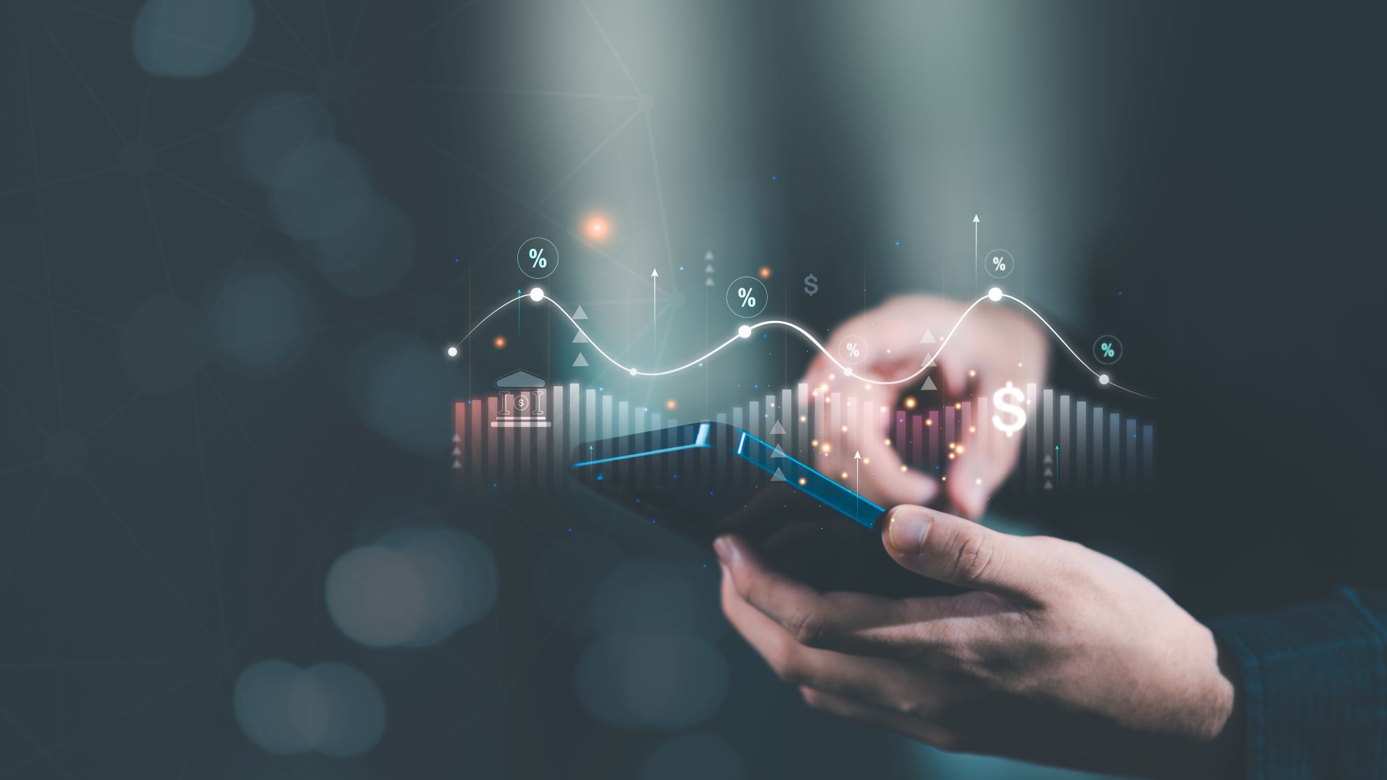 Imagen de una mano sujetando un mÃ³vil sobre un grÃ¡fico bursÃ¡til en un artÃ­culo sobre ETF de dividendos