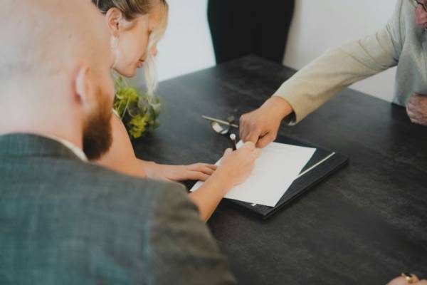 Imagen de varias personas firmando un documento en un artículo sobre los FRA