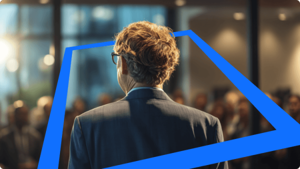 Vista traseira de Bill Gates a discursar para uma audiência numa conferência, simbolizando liderança, inovação e estratégia corporativa.