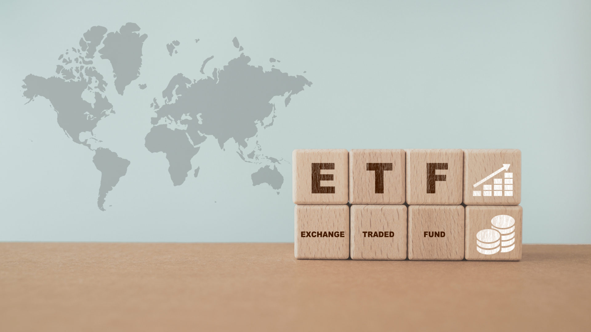 wooden cube with ETF text , Exchange Traded Fund, increasing graph and icon on world map background including copy space
