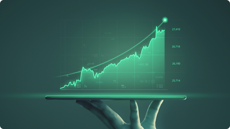 A hand holding a tablet displaying a graph referring to an investment growth