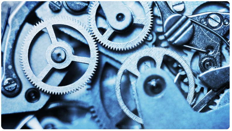 Vue rapprochÃ©e d'un mÃ©canisme d'horlogerie, avec des engrenages et des composants finement travaillÃ©s, illustrant la mÃ©canique de prÃ©cision.