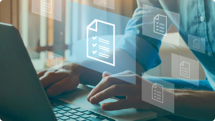 man sitting in front of laptop with documents graphics 